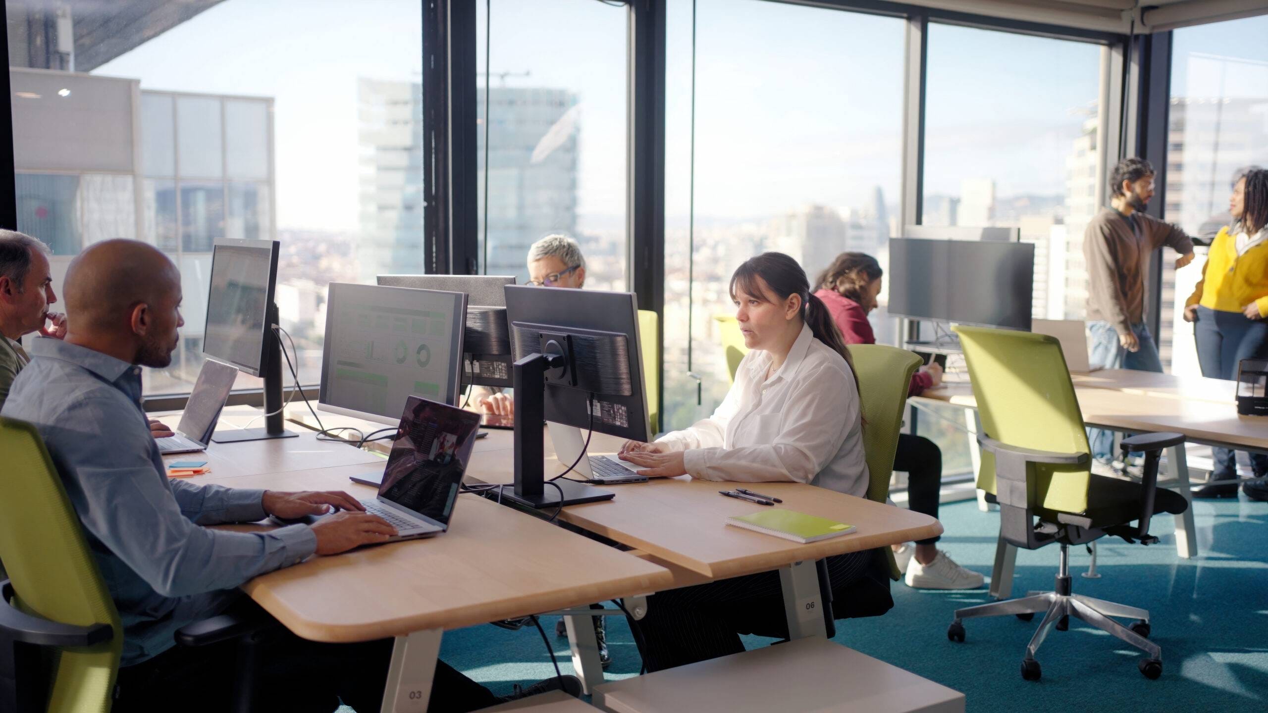 Colleagues working with computers in modern office