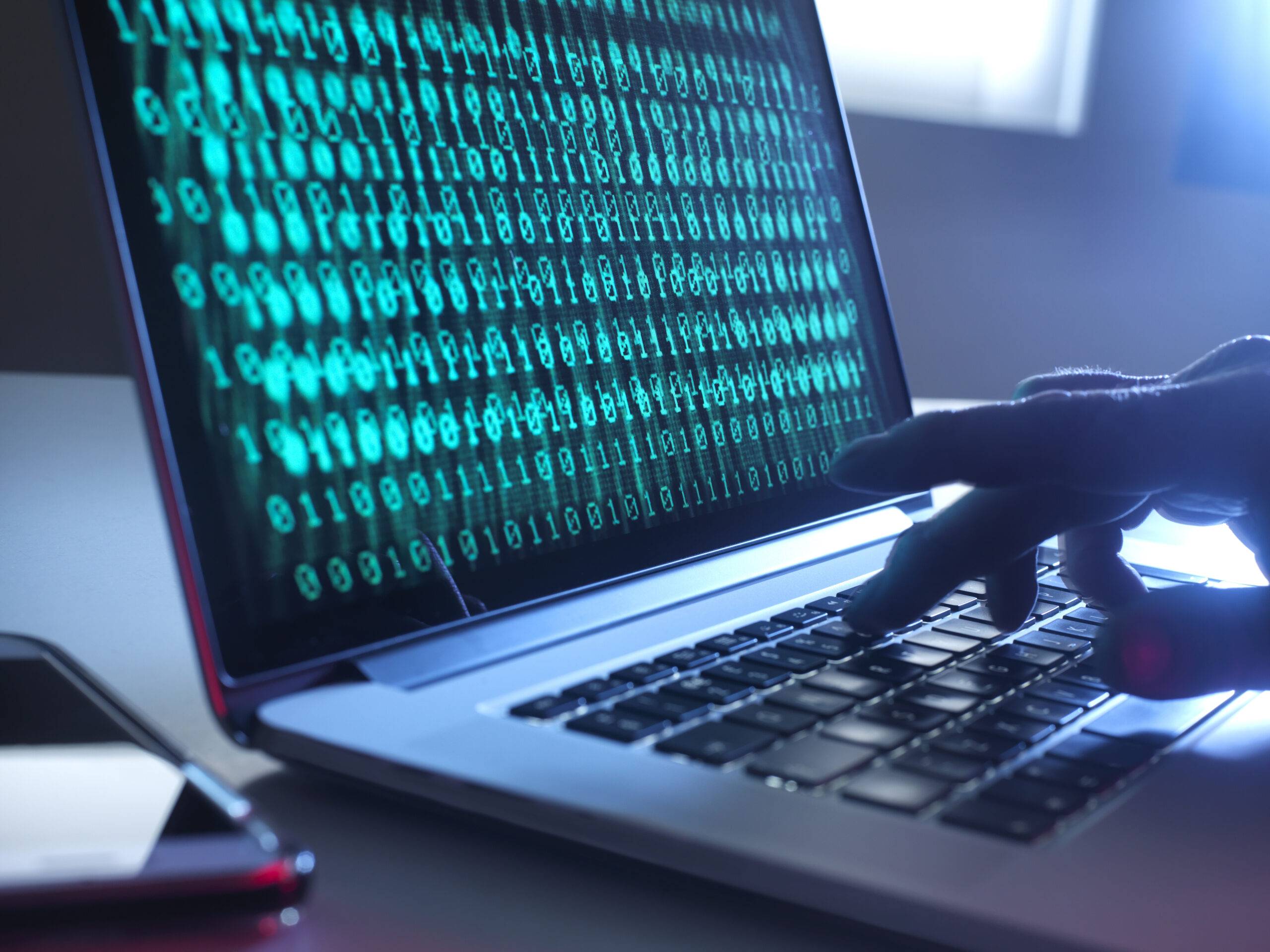 Cyber Crime, laptop computer being hacked